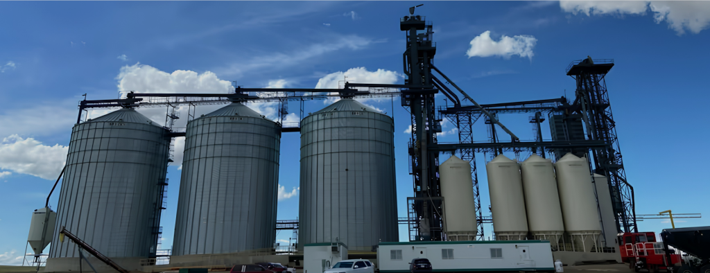 Grain terminal facility near Marengo, Saskatchewan, featuring steel grain bins, storage silos, and grain handling equipment.